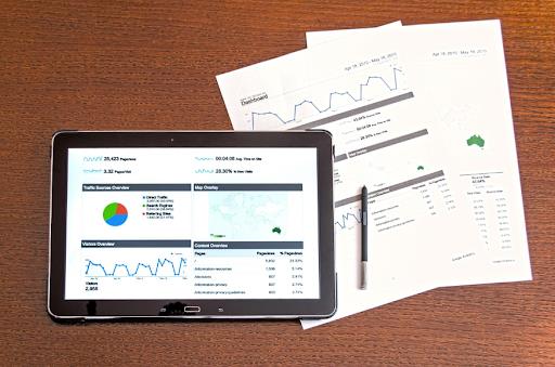 Tablet and documents displaying predictive analytics charts and graphs